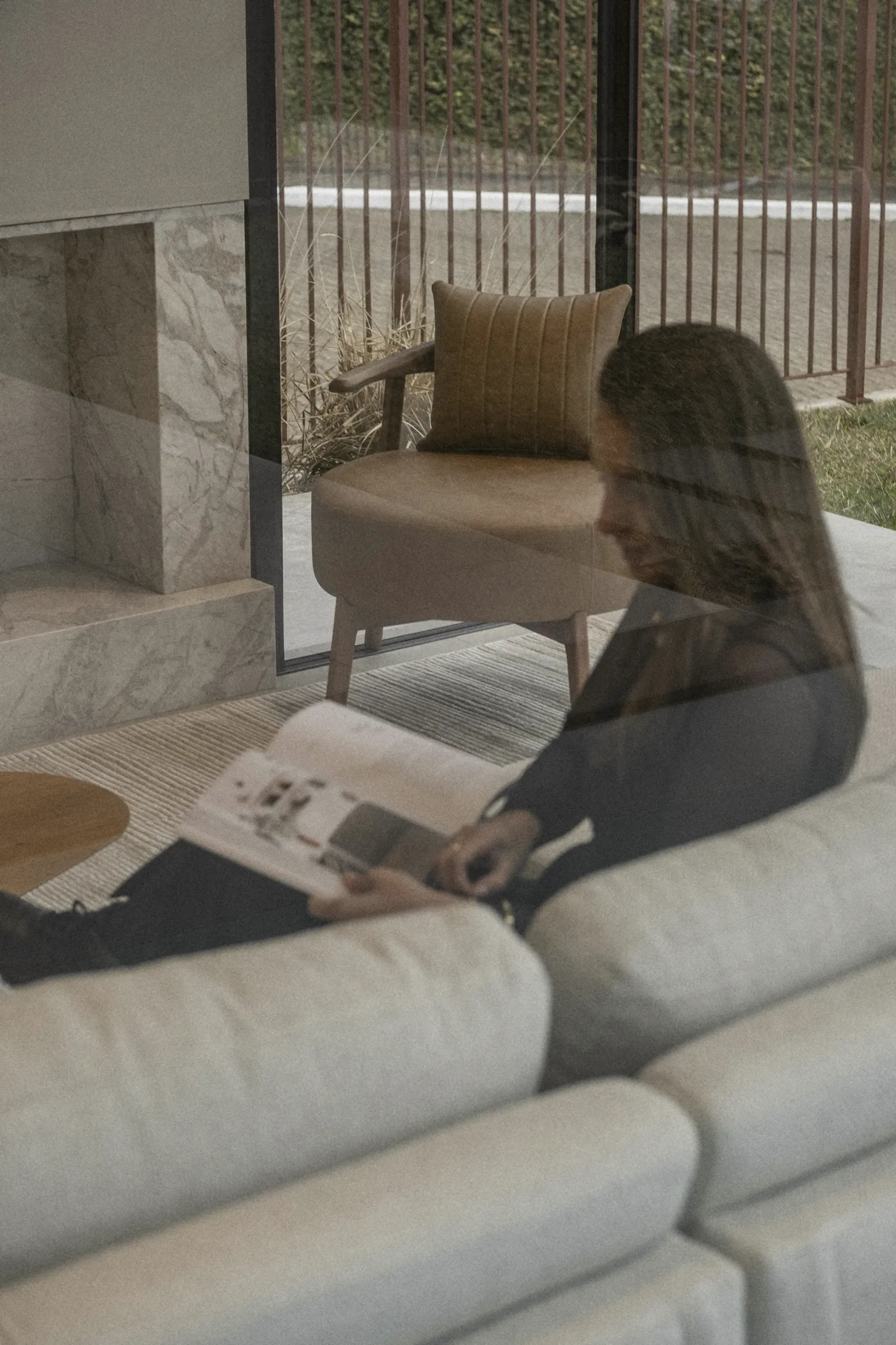 Reading on the sofa by the marble fireplace