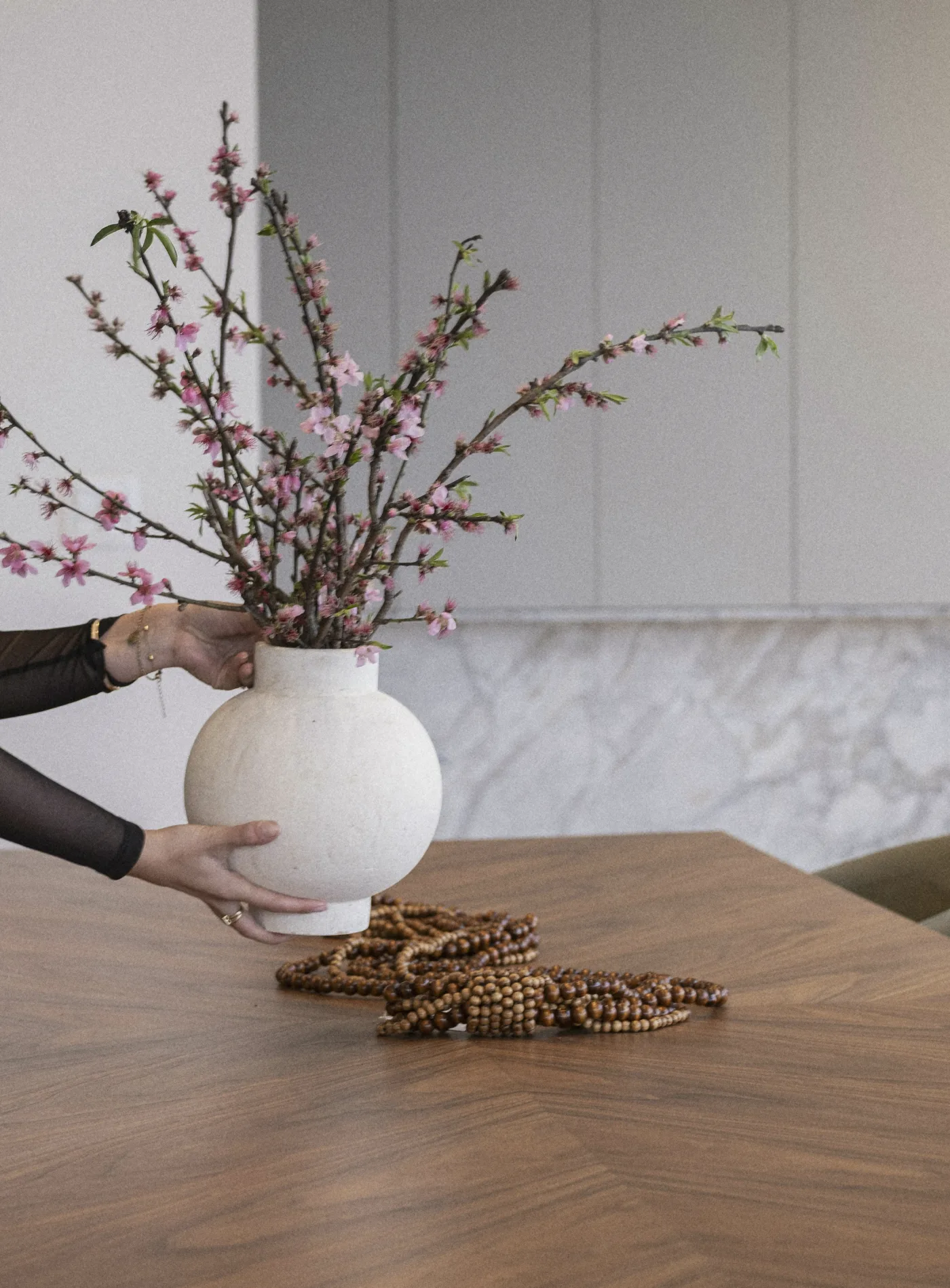 A white vase set on the walnut table